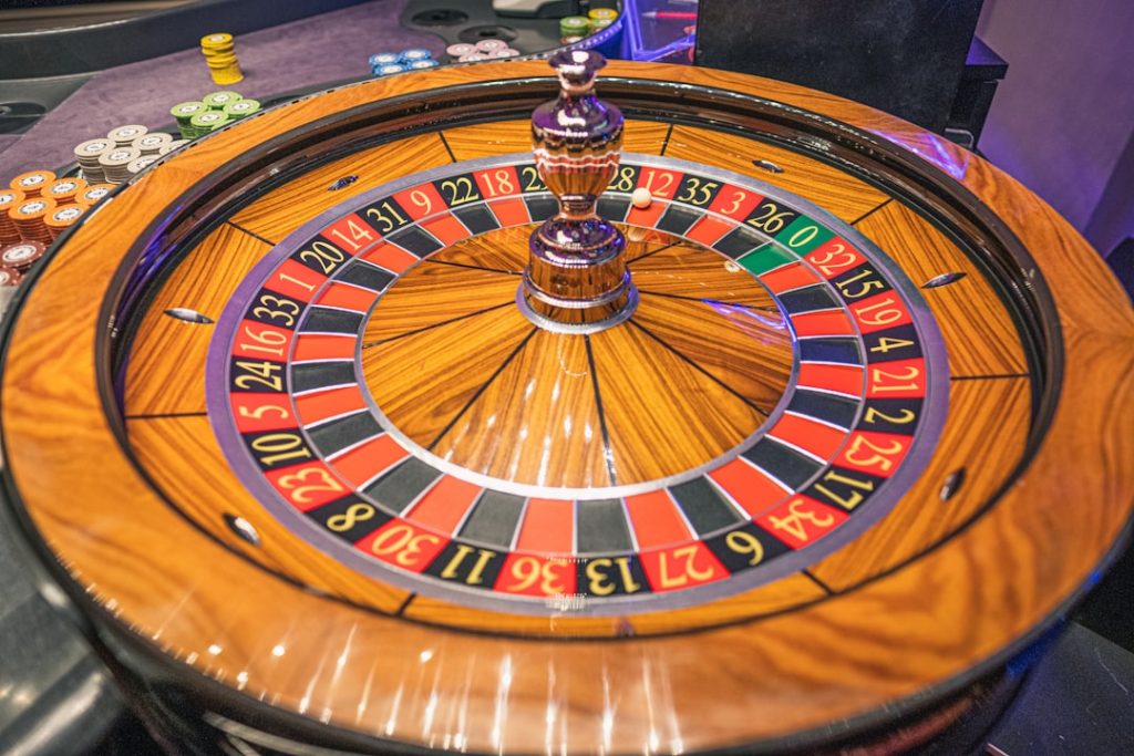 Glowing digital casino interface with European city skyline reflected on dark glossy surface at night