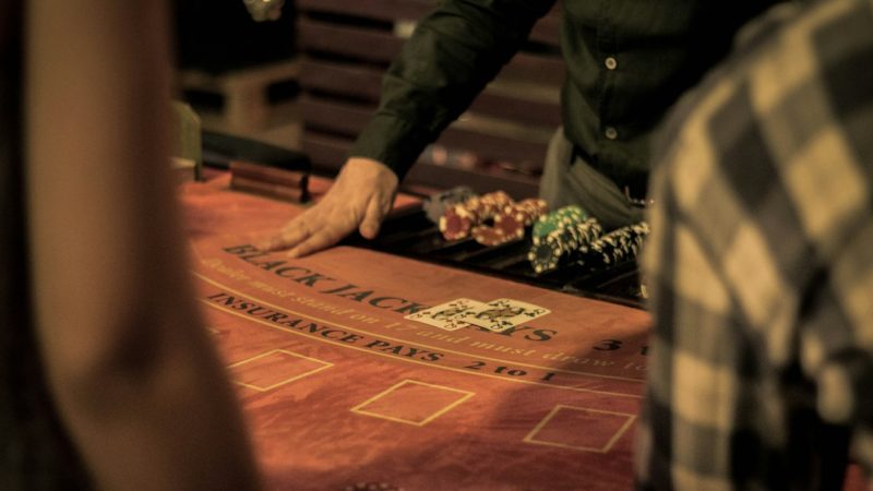 Glowing digital casino interface with Eastern European city skyline reflected on dark glass surface at night